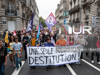 People march holding a banner that reads, 'A single solution destitution', during a protest after the appointment of a right-wing prime mini...