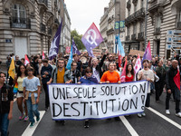 People march holding a banner that reads, 'A single solution destitution', during a protest after the appointment of a right-wing prime mini...