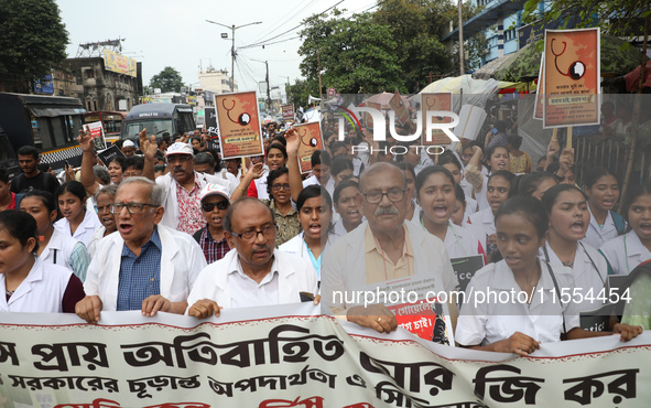 Medical students and doctors shout slogans during a protest rally towards Raj Bhavan, the official residence of the Governor of West Bengal...