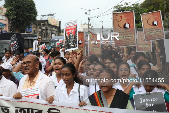 Medical students and doctors shout slogans during a protest rally towards Raj Bhavan, the official residence of the Governor of West Bengal...