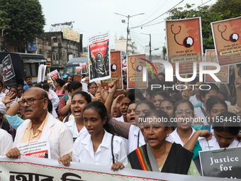 Medical students and doctors shout slogans during a protest rally towards Raj Bhavan, the official residence of the Governor of West Bengal...