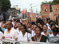 Medical students and doctors shout slogans during a protest rally towards Raj Bhavan, the official residence of the Governor of West Bengal...