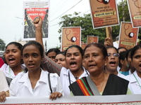 Medical students and doctors shout slogans during a protest rally towards Raj Bhavan, the official residence of the Governor of West Bengal...