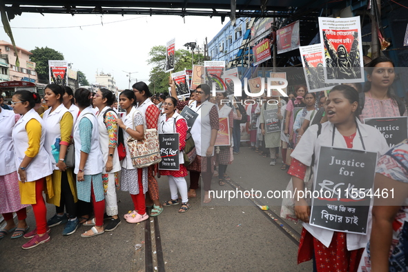 Medical students and doctors shout slogans during a protest rally towards Raj Bhavan, the official residence of the Governor of West Bengal...