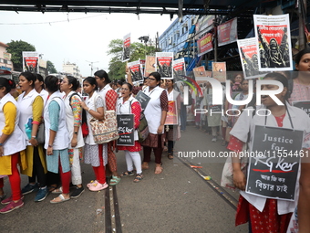 Medical students and doctors shout slogans during a protest rally towards Raj Bhavan, the official residence of the Governor of West Bengal...