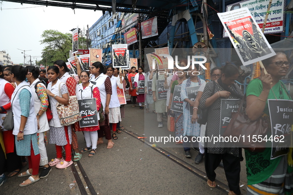 Medical students and doctors shout slogans during a protest rally towards Raj Bhavan, the official residence of the Governor of West Bengal...