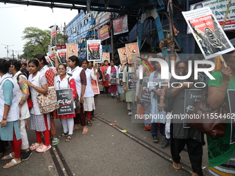 Medical students and doctors shout slogans during a protest rally towards Raj Bhavan, the official residence of the Governor of West Bengal...