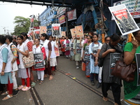 Medical students and doctors shout slogans during a protest rally towards Raj Bhavan, the official residence of the Governor of West Bengal...