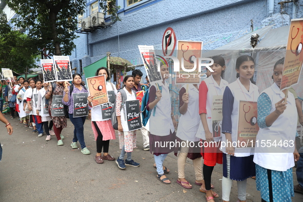 Medical students and doctors shout slogans during a protest rally towards Raj Bhavan, the official residence of the Governor of West Bengal...