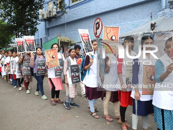 Medical students and doctors shout slogans during a protest rally towards Raj Bhavan, the official residence of the Governor of West Bengal...