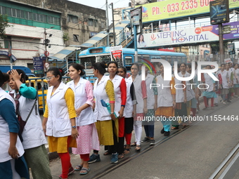 Medical students and doctors shout slogans during a protest rally towards Raj Bhavan, the official residence of the Governor of West Bengal...