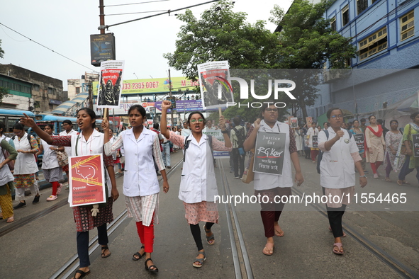 Medical students and doctors shout slogans during a protest rally towards Raj Bhavan, the official residence of the Governor of West Bengal...