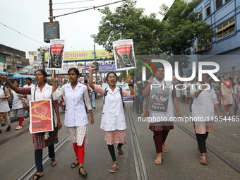 Medical students and doctors shout slogans during a protest rally towards Raj Bhavan, the official residence of the Governor of West Bengal...