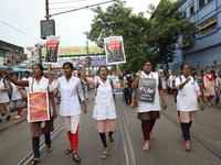 Medical students and doctors shout slogans during a protest rally towards Raj Bhavan, the official residence of the Governor of West Bengal...