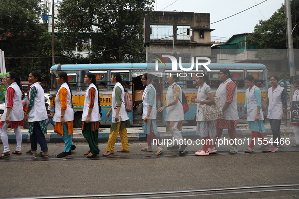 Medical students and doctors shout slogans during a protest rally towards Raj Bhavan, the official residence of the Governor of West Bengal...