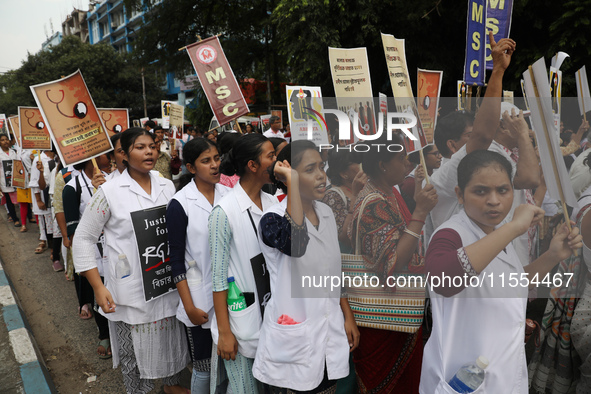 Medical students and doctors shout slogans during a protest rally towards Raj Bhavan, the official residence of the Governor of West Bengal...