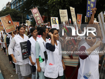 Medical students and doctors shout slogans during a protest rally towards Raj Bhavan, the official residence of the Governor of West Bengal...