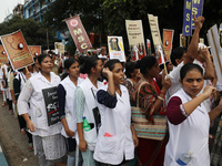 Medical students and doctors shout slogans during a protest rally towards Raj Bhavan, the official residence of the Governor of West Bengal...