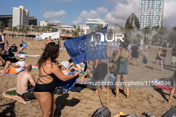 Dozens of Barcelona residents protest on the Somorrostro beach in the Barceloneta neighborhood against the America's Cup 2024, in Barcelona,...