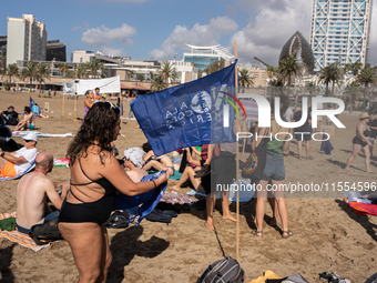 Dozens of Barcelona residents protest on the Somorrostro beach in the Barceloneta neighborhood against the America's Cup 2024, in Barcelona,...