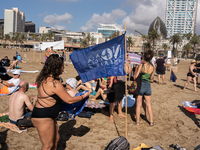 Dozens of Barcelona residents protest on the Somorrostro beach in the Barceloneta neighborhood against the America's Cup 2024, in Barcelona,...