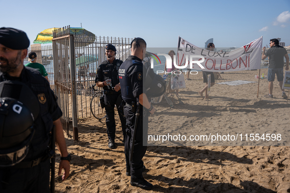 Dozens of Barcelona residents protest on the Somorrostro beach in the Barceloneta neighborhood against the America's Cup 2024, in Barcelona,...