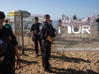 Dozens of Barcelona residents protest on the Somorrostro beach in the Barceloneta neighborhood against the America's Cup 2024, in Barcelona,...