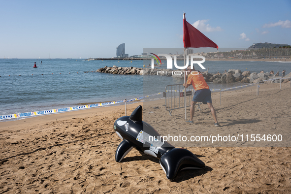 Dozens of Barcelona residents protest on the Somorrostro beach in the Barceloneta neighborhood against the America's Cup 2024, in Barcelona,...