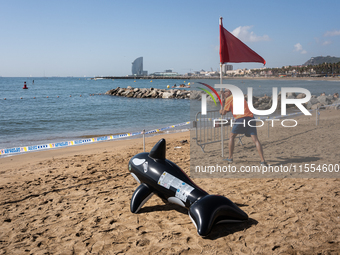 Dozens of Barcelona residents protest on the Somorrostro beach in the Barceloneta neighborhood against the America's Cup 2024, in Barcelona,...