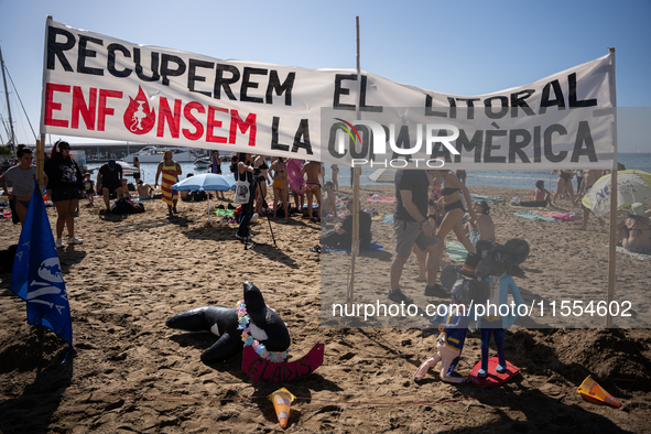 Dozens of Barcelona residents protest on the Somorrostro beach in the Barceloneta neighborhood against the America's Cup 2024, in Barcelona,...