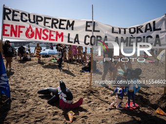 Dozens of Barcelona residents protest on the Somorrostro beach in the Barceloneta neighborhood against the America's Cup 2024, in Barcelona,...