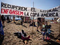 Dozens of Barcelona residents protest on the Somorrostro beach in the Barceloneta neighborhood against the America's Cup 2024, in Barcelona,...