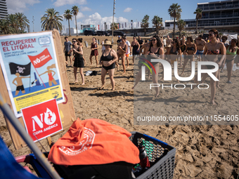 Dozens of Barcelona residents protest on the Somorrostro beach in the Barceloneta neighborhood against the America's Cup 2024, in Barcelona,...