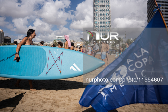 Dozens of Barcelona residents protest on the Somorrostro beach in the Barceloneta neighborhood against the America's Cup 2024, in Barcelona,...