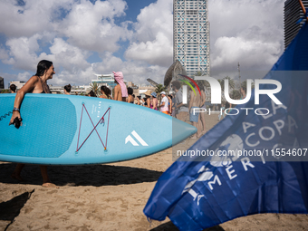 Dozens of Barcelona residents protest on the Somorrostro beach in the Barceloneta neighborhood against the America's Cup 2024, in Barcelona,...