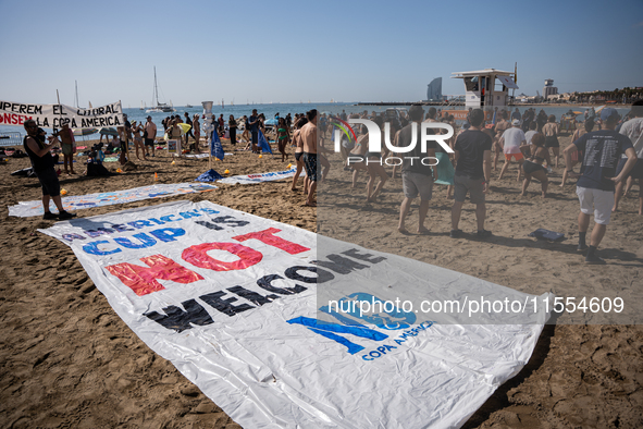 Dozens of Barcelona residents protest on the Somorrostro beach in the Barceloneta neighborhood against the America's Cup 2024, in Barcelona,...