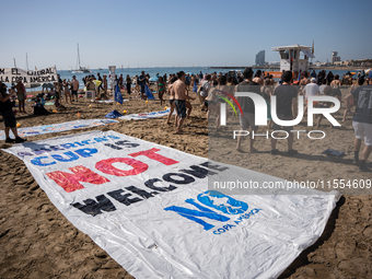 Dozens of Barcelona residents protest on the Somorrostro beach in the Barceloneta neighborhood against the America's Cup 2024, in Barcelona,...