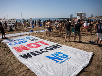 Dozens of Barcelona residents protest on the Somorrostro beach in the Barceloneta neighborhood against the America's Cup 2024, in Barcelona,...