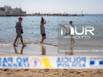 Dozens of Barcelona residents protest on the Somorrostro beach in the Barceloneta neighborhood against the America's Cup 2024, in Barcelona,...