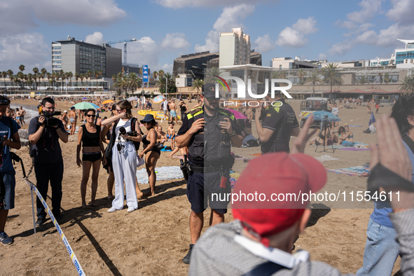 Dozens of Barcelona residents protest on the Somorrostro beach in the Barceloneta neighborhood against the America's Cup 2024, in Barcelona,...