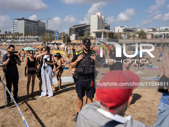 Dozens of Barcelona residents protest on the Somorrostro beach in the Barceloneta neighborhood against the America's Cup 2024, in Barcelona,...