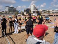 Dozens of Barcelona residents protest on the Somorrostro beach in the Barceloneta neighborhood against the America's Cup 2024, in Barcelona,...