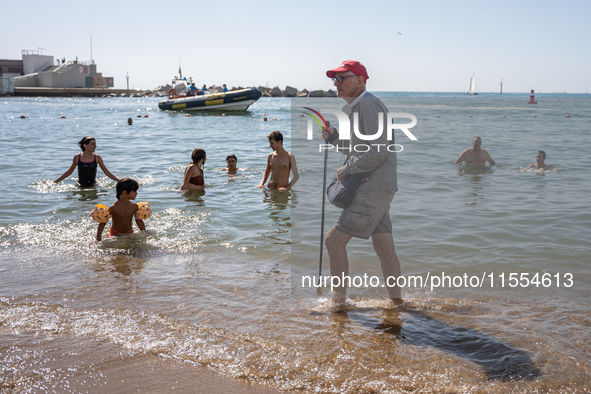 Dozens of Barcelona residents protest on the Somorrostro beach in the Barceloneta neighborhood against the America's Cup 2024, in Barcelona,...