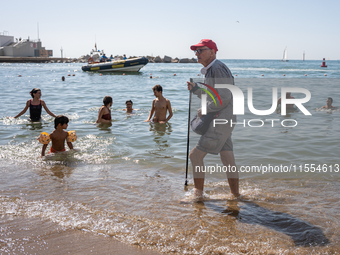 Dozens of Barcelona residents protest on the Somorrostro beach in the Barceloneta neighborhood against the America's Cup 2024, in Barcelona,...