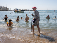 Dozens of Barcelona residents protest on the Somorrostro beach in the Barceloneta neighborhood against the America's Cup 2024, in Barcelona,...