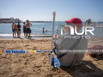 Dozens of Barcelona residents protest on the Somorrostro beach in the Barceloneta neighborhood against the America's Cup 2024, in Barcelona,...