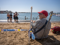 Dozens of Barcelona residents protest on the Somorrostro beach in the Barceloneta neighborhood against the America's Cup 2024, in Barcelona,...