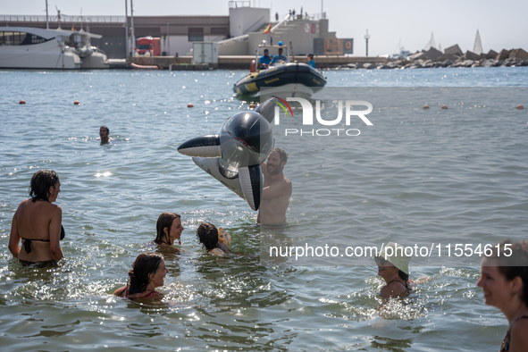 Dozens of Barcelona residents protest on the Somorrostro beach in the Barceloneta neighborhood against the America's Cup 2024, in Barcelona,...