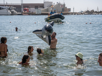 Dozens of Barcelona residents protest on the Somorrostro beach in the Barceloneta neighborhood against the America's Cup 2024, in Barcelona,...