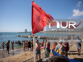 Dozens of Barcelona residents protest on the Somorrostro beach in the Barceloneta neighborhood against the America's Cup 2024, in Barcelona,...